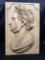 Julius Caesar profile carved in wood.