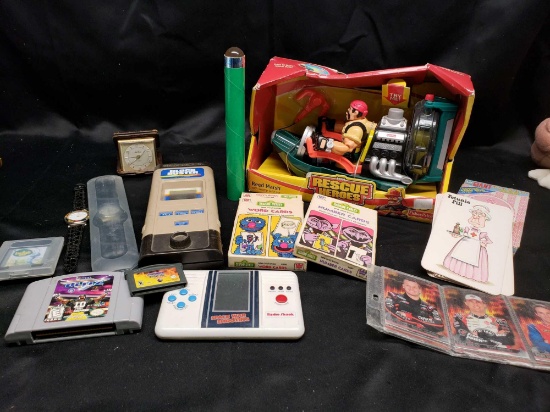 Mixed lot. Watches. Rescue heros action figure. Hand held games. Untested.