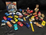 A few Hot Wheels and Vintage toy cars and trucks with some other toys.