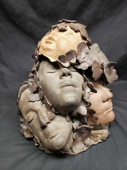Handmade Sculpture of faces in the leaves