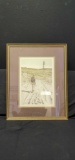 Framed signed artwork of man on beach