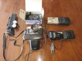 Cannon and Olympus cameras with cases and accessories.