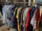 Rack of new collar shirts. Hawaiian shirts. Tee shirts. Aprons. Sweatshirts.