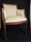 Vintage wood frame chair with floral upholstery.