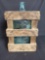 Wood crate with glass 4 gallon water jug inside.