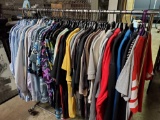 Rack of new collar shirts. Hawaiian shirts. Tee shirts. Aprons. Sweatshirts.