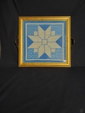 Framed needle point design with black felt backing.