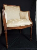 Vintage wood frame chair with floral upholstery.