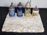 4 stien mugs. Floral design tablecloth.