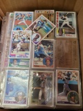 Box of sports cards in binder sleeves