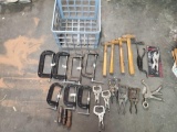 small crate of different kinds of metal clamps and ball point hammers