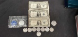 3 blue seal dollar bills. 8 half dolar coins. 1 Eisenhower silver dollar.1 1776-1986 one dollar coin