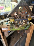 cuckoo clock on bench with weights