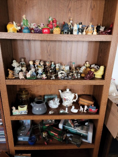 Bookcase contents - Porcelain figurines Die Cast Cars Coin Bank Pottery