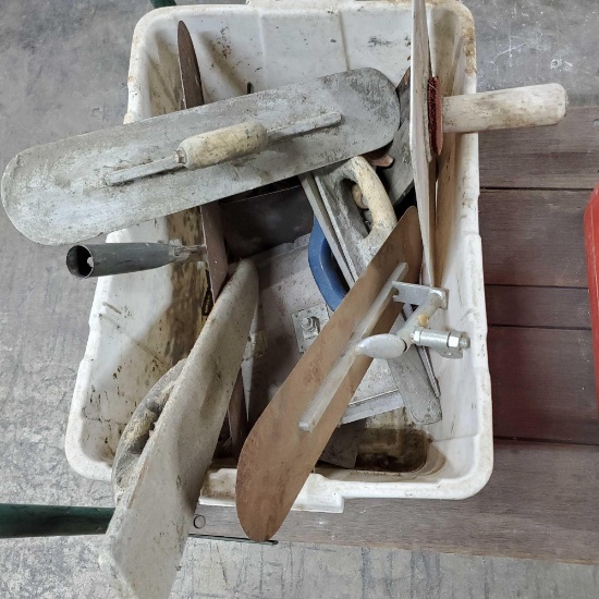 Bin full of concrete tools floats trials edgers etc.