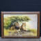 Framed oil/canvas artwork lion/lioness under bush signed Kibue