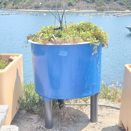 Large 3 legged tub filled with potting soil various flowers