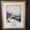 Framed artwork print titled Moonlit Village signed Thomas Kinkade with COA on back