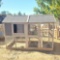 2 story wood/wire mesh with asphalt rooftop chicken coop