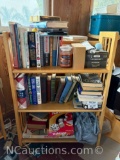 bookshelf and everything it includes books, games, candles, and Mt Misery Rd