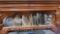 Cupboard full of misc cookware cassarole dishs cookie sheets cutting boards muffin tons etc.