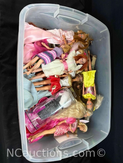 bin of Barbie dolls and cloths