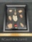 framed collection of Native American arrowheads and artifacts