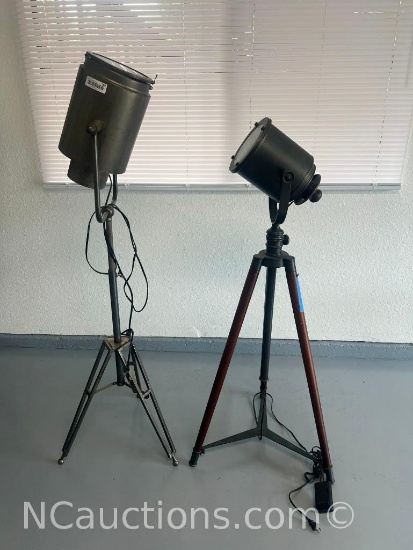 two vintage tripod floodlights