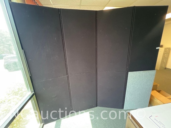 Dark fabric-covered folding privacy or acoustic room divider standing partition