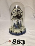 Elvis Presley glass dome tabletop clock with guitar mobile and printed signature.