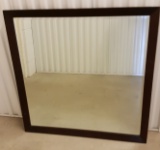 Large beveled mirror. Wood backing. Some scratches around frame 35