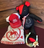 A Savannah Station teddy bear made by June Jones along with a cap, large t-shirt and horseshoe