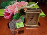 Small clock and floral arrangement