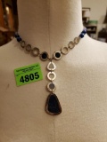 silver and blue necklace with teardrop shape
