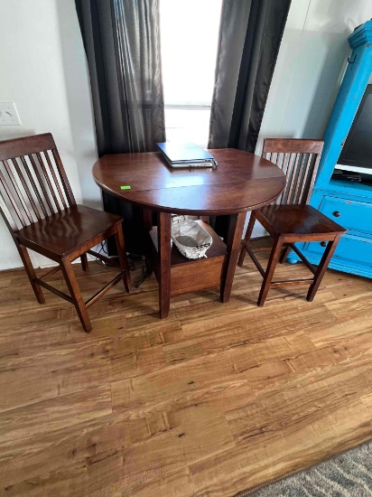 Small dining set with a table and two chairs.