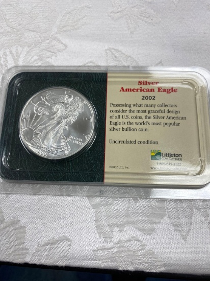 Silver American eagle 2002 US mint 99.93 silver and 0.7% copper diameter 40.6 mm with reeded edge