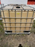 2 chemical totes in cages