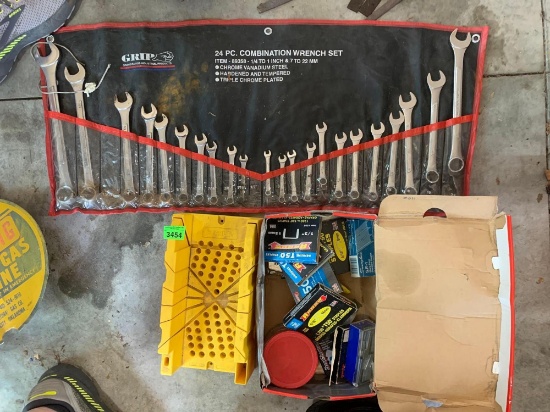 22. Standard and metric opening wrenches in pouch, staple assortment, and miter box.