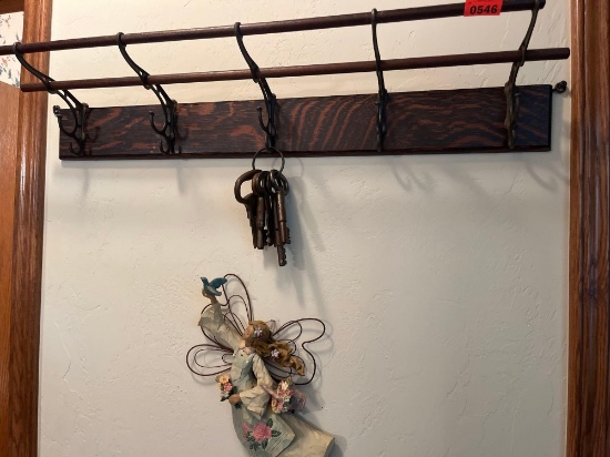 Coat rack, keys, flying angel with dove