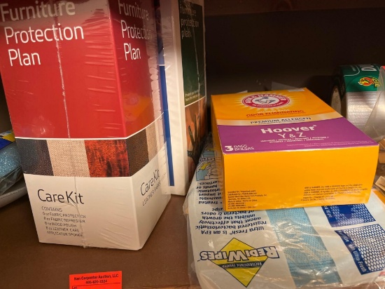 Furniture carekit, vacuum bags, duct tape, light fixture tray with various items in a Q-tip brush