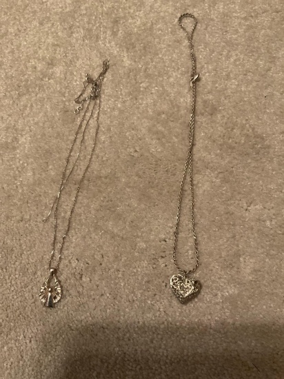 A guardian angel necklace, and a heart necklace
