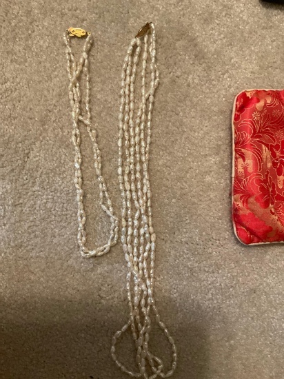Pearl necklaces with red and white bag