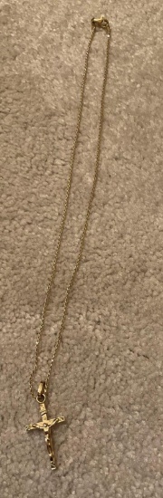Golden necklace with golden cross with Jesus on it