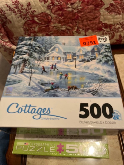Three puzzles, one with plastic shrink wrap still on