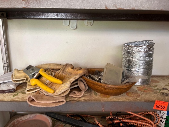 Gloves, pruners pot, full of nails, water hose end nutcrackers screws, dryer hose vent