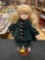 Vintage Porcelain Little Girl Doll with Green Outfit and Stand