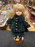 Vintage Porcelain Little Girl Doll with Green Outfit and Stand