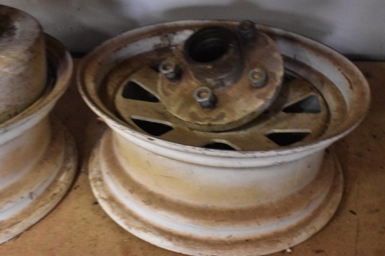 2 vehicle rims and axle hubs