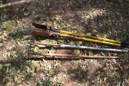 2 rakes and a post hole digger
