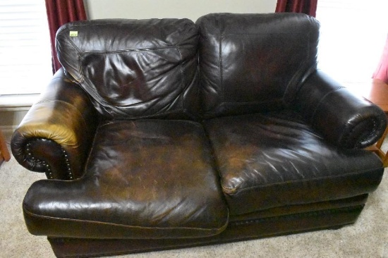 Leather Love seat with a little wear on the seat and arm rest, Solid love seat and very comfortable